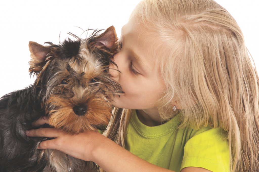 Girl kissing dog