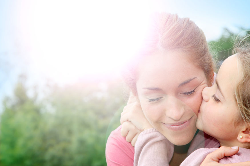 Daughter kissing Mom's Cheek