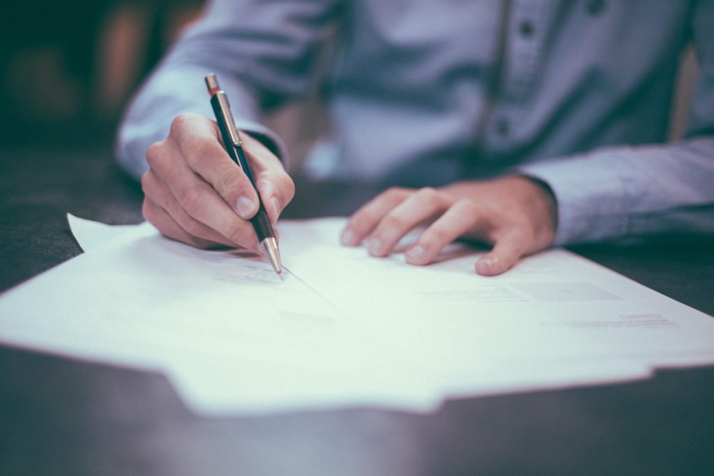 a man sitting down to create a family budget on paper