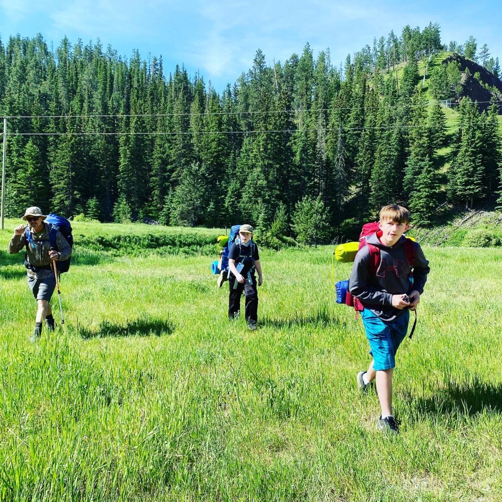 Boys learning backpacking skills