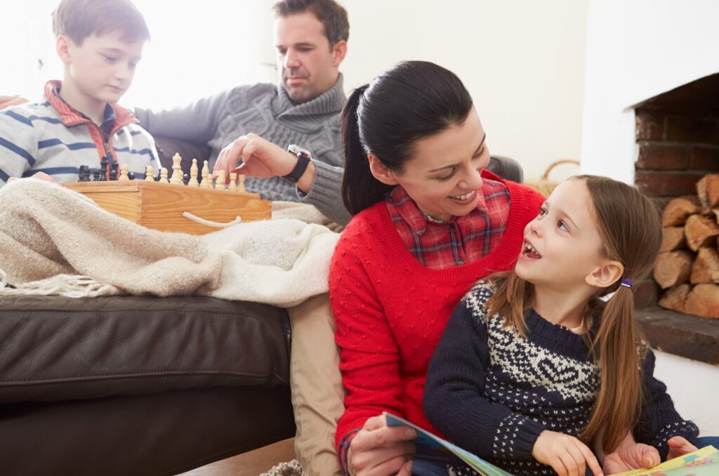 A family relaxing together on a couch during the holidays.