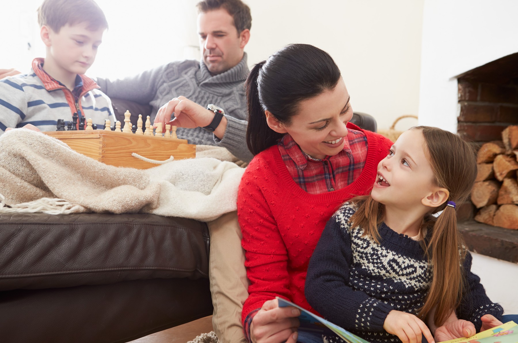 A family relaxing together on a couch during the holidays.
