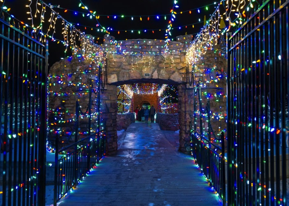 A walkway illuminated with Christmas lights at Storybook Island.